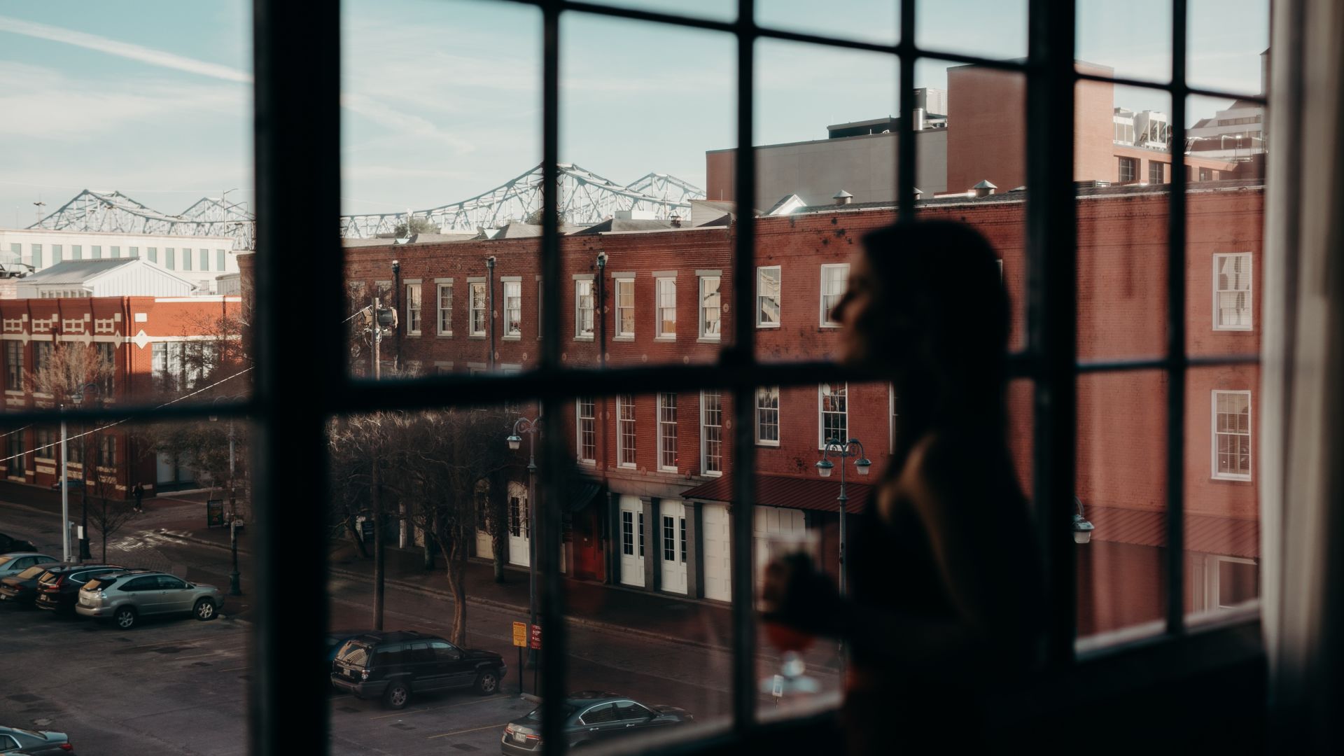 A Person Standing In Front Of A Window