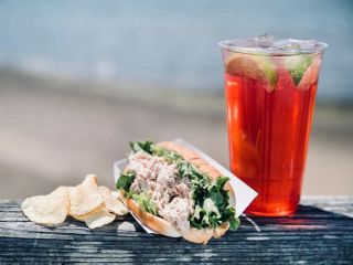 Sandwich and drink by the water.