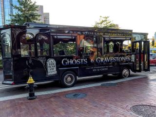 Ghosts &amp; Gravestone bus on the street.